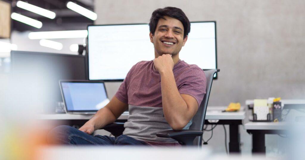 male it professional at desk smiling