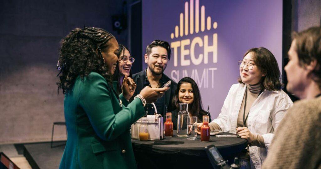 group of tech professionals networking around a table