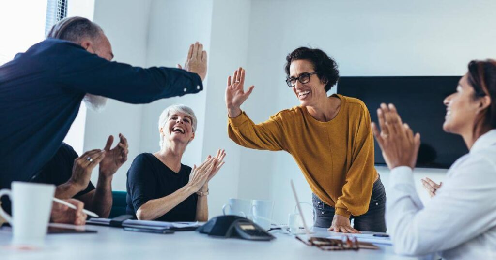 team high fiving after successful erp implementation