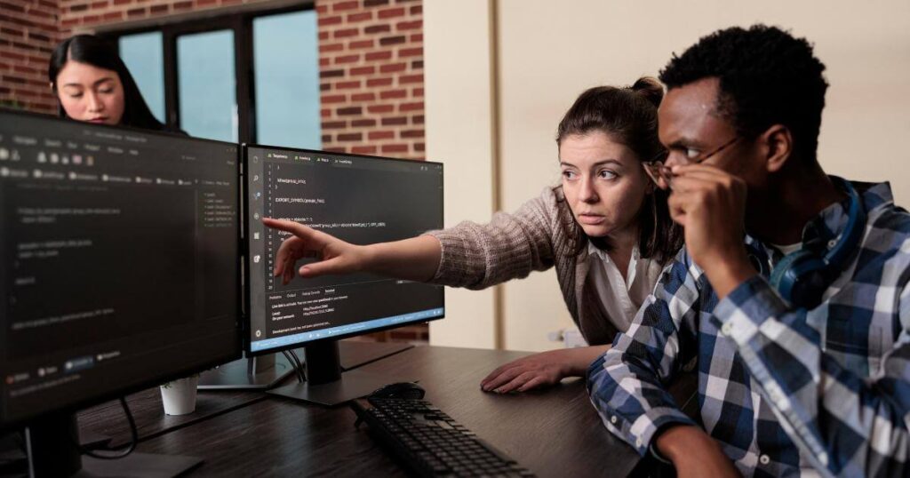 tech consultant showing team mate something on screen