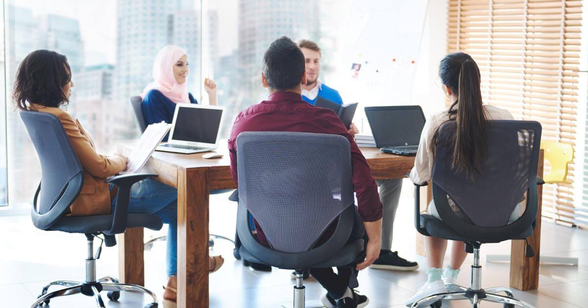 Overcome Hiring Freezes main team meeting discussing projects