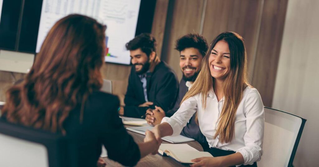 team shaking hands with it consultant