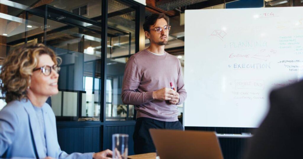 Team member presenting a planning strategy; no one person owns AI adoption