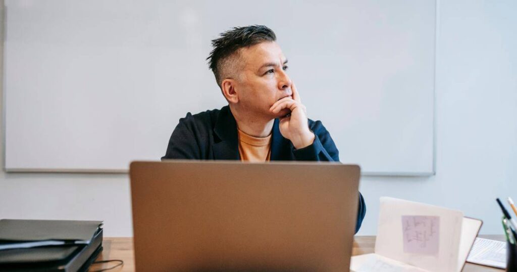 Enterprise IT leader pausing thoughtfully at his laptop figuring out what actually needs to change
