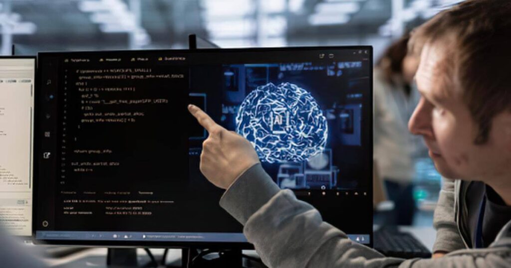 Developer pointing at AI code on screen while a colleague looks on